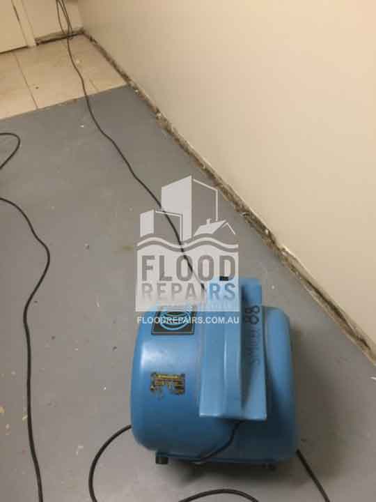 wall and floor before Flood Restoration & Repairs cleaning and repairing